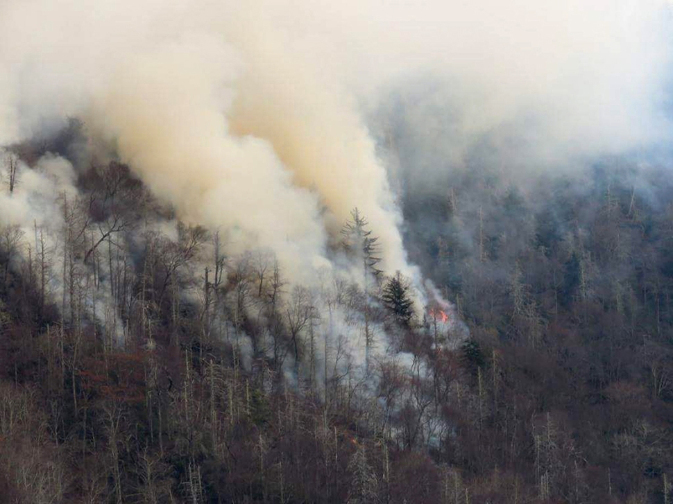 Smoke plumes from wildfires are shown in the Great Smokey Mountains near Gatlinburg